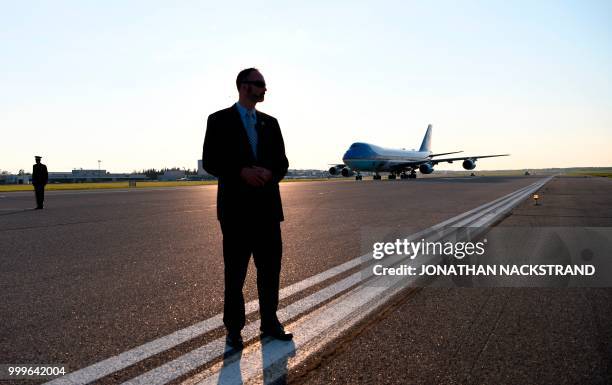 Security officer guards as Air Force One sits on the tarmac upon arrival at Helsinki-Vantaa Airport in Helsinki, on July 15, 2018 on the eve of a...