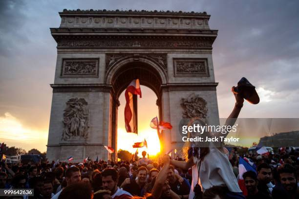 French football fans celebrate around the Arc de Triomph after France's victory against Croatia in the World Cup Final on July 15, 2018 in Paris,...
