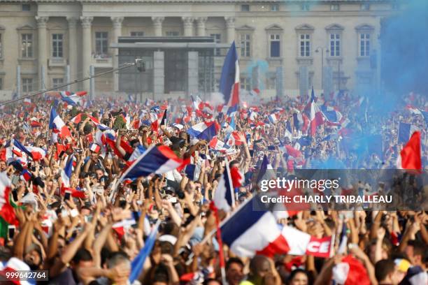 France supporters celebrate on the fan zone, after France won the Russia 2018 World Cup final football match between France and Croatia, on the Champ...