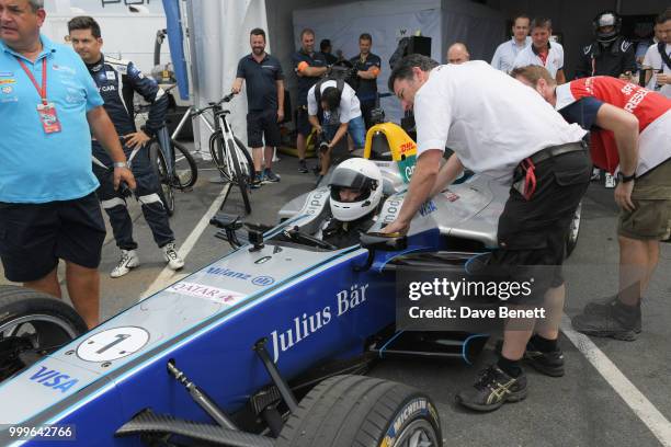 Liv Tyler gets ready to drive a Formula E racing car at the Formula E 2018 Qatar Airways New York City E-Prix, the double header season finale of the...