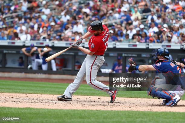 Daniel Murphy of the Washington Nationals hits a two run single in the seventh inning against the New York Mets during their game at Citi Field on...
