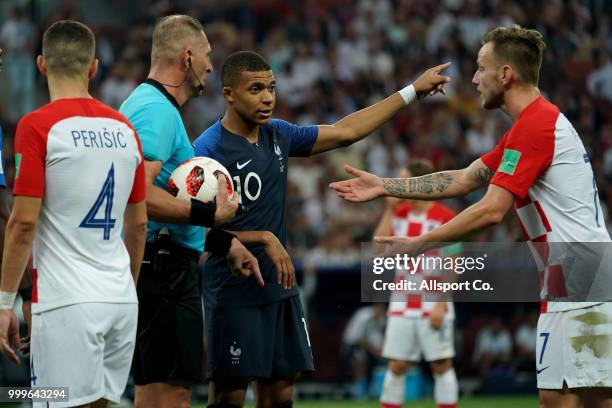 Kylian Mbappe of France makes a point to Ivan Rakitic of Croatia as the referee looks on during the 2018 FIFA World Cup Russia Final between France...