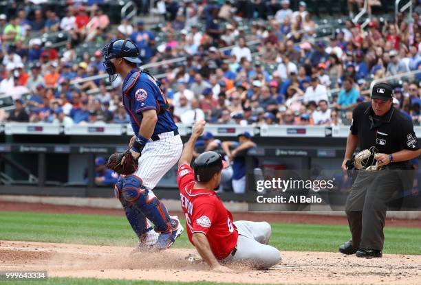 Anthony Rendon of the Washington Nationals scores against Devin Mesoraco of the New York Mets in the seventh innng during their game at Citi Field on...