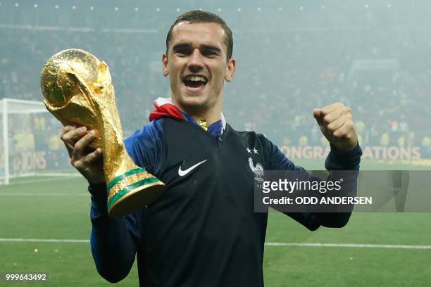 France's forward Antoine Griezmann celebrates with the World Cup trophy after the Russia 2018 World Cup final football match between France and...