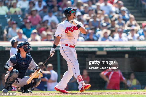 Catcher Kyle Higashioka of the New York Yankees and Michael Brantley of the Cleveland Indians watch a solo home run clear the right field fence...