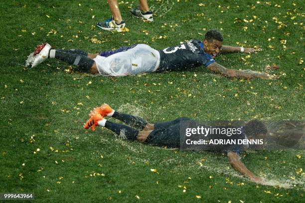 France's forward Thomas Lemar and France's defender Presnel Kimpembe celebrate at the end of the Russia 2018 World Cup final football match between...