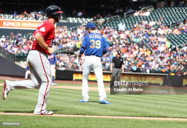 Matt Adams of the Washington Nationals scores after Adam Eaton of the Washington Nationals is hit by a pitch with the bases loaded in the seventh...