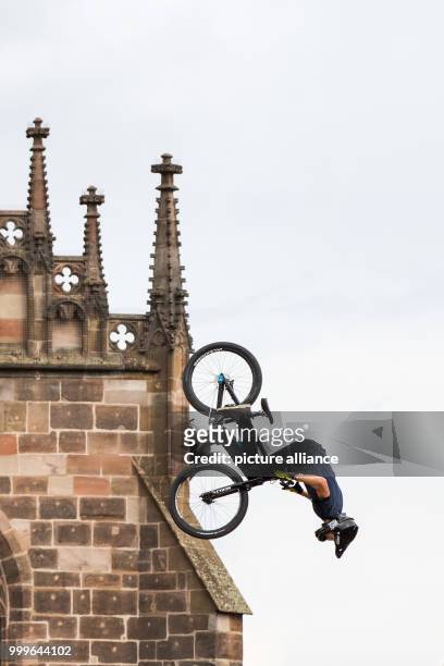 The freestyle mountain biker Jakub Vencl from the Czech Republic jumps in front of a backdrop of the Frauenkirche during the finals of the 'Red Bull...