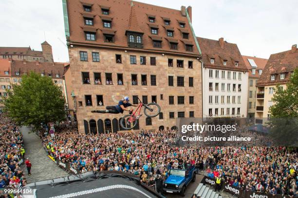 The freestyle mountain biker Szymon Godziek from Poland jumps over a ramp during the the first final round of the 'Red Bull District Ride' in...