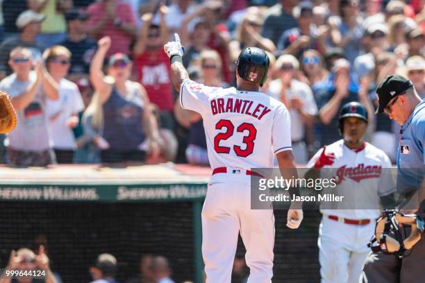 Michael Brantley of the Cleveland Indians celebrates with fans after he hit a solo home run to take the lead during the eighth inning against the New...
