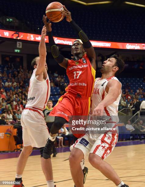Dennis Schroeder of Germany in action against Manuchar Markoishvili and Zaza Pachulia of Georgia during the EuroBasket 2017 Group B game between the...