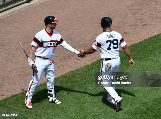 Jose Abreu of the Chicago White Sox is greeted by Matt Davidson of the Chicago White Sox after scoring against the Kansas City Royals during the...