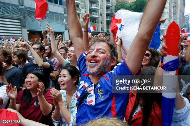 French fans react as France scores a goal while they watch the World Cup final match between France vs Croatia on July 15, 2018 in New York. - The...
