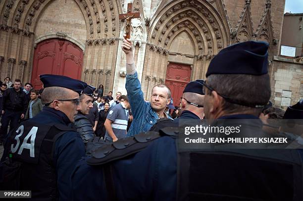 Man wave a rood in front of policemen on May 18, 2010 in Lyon, as part of a "kiss-in" event for the world day against homophobia. Clashes appear...