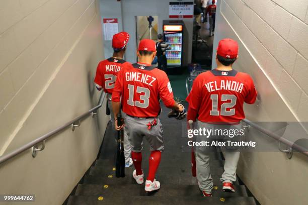 Seuly Matias, Andres Gimenez, and Jorge Velandia of the World Team head to the field during batting practice prior to the SiriusXM All-Star Futures...