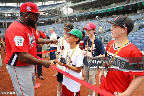 David Ortiz of the World Team meets with Make-A-Wish kids during batting practice prior to the SiriusXM All-Star Futures Game at Nationals Park on...