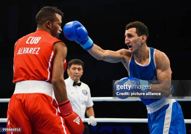 Lazaro Alvarez Estrada of Cuba fighting Sofiane Oumiha of France in the lightweight final bout of the AIBA World Boxing Championships in Hamburg,...