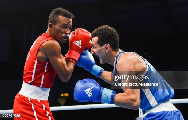 Lazaro Alvarez Estrada of Cuba fighting Sofiane Oumiha of France in the lightweight final bout of the AIBA World Boxing Championships in Hamburg,...