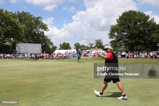 Laura Davies of England waves to fans as she walks up to the 18th green during the final round of the U.S. Senior Women's Open at Chicago Golf Club...