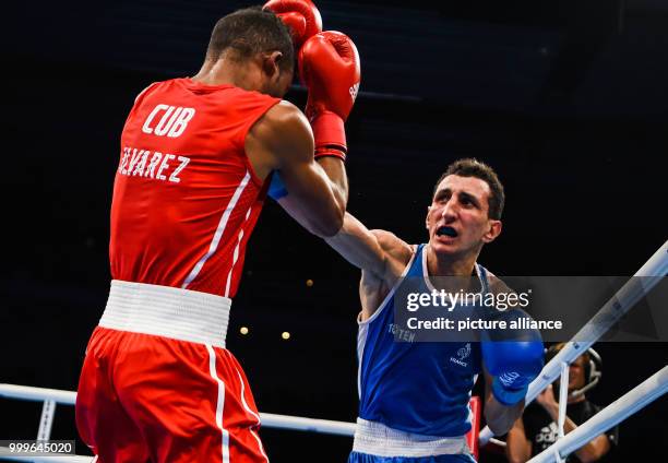 Lazaro Alvarez Estrada of Cuba fighting Sofiane Oumiha of France in the lightweight final bout of the AIBA World Boxing Championships in Hamburg,...