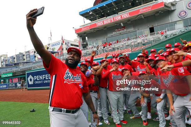 David Ortiz and members of the World Team pose for a selfie prior to the SiriusXM All-Star Futures Game at Nationals Park on Sunday, July 15, 2018 in...