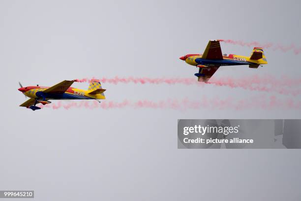 "Extra 330sc" model planes flying at the "Mega Flugshow" air show in Goettingen, Germany, 2 September 2017. Around 90 participants from various...