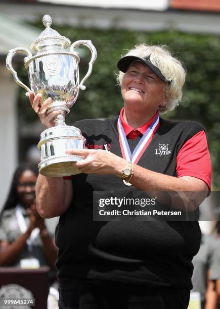 Laura Davies of England celebrates with the U.S. Senior Women's Open trophy after winning in the final round at Chicago Golf Club on July 15, 2018 in...