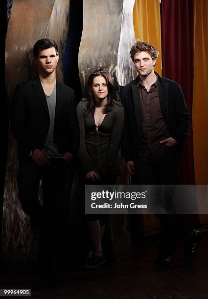 Actors Taylor Lautner, Kristen Stewart and Robert Pattinson pose for a private photo shoot at Marche on May 5, 2010 in Chicago, Illinois.