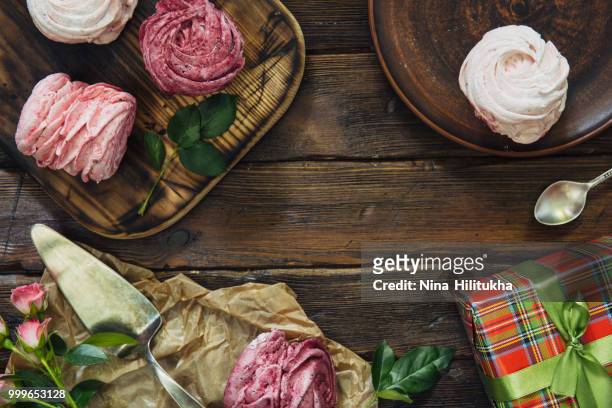 blueberry meringues, flowers on wooden background. copy space. - nina stock pictures, royalty-free photos & images