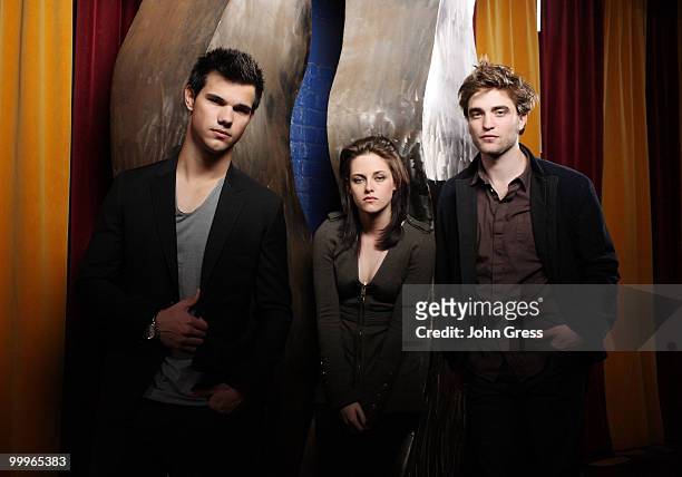 Actors Taylor Lautner, Kristen Stewart and Robert Pattinson pose for a private photo shoot at Marche on May 5, 2010 in Chicago, Illinois.