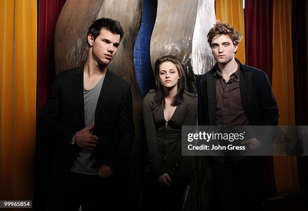 Actors Taylor Lautner, Kristen Stewart and Robert Pattinson pose for a private photo shoot at Marche on May 5, 2010 in Chicago, Illinois.