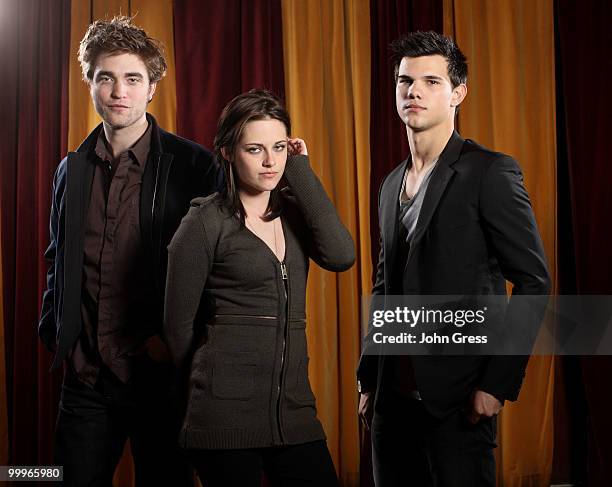 Actors Robert Pattinson, Kristen Stewart and Taylor Lautner pose for a private photo shoot at Marche on May 5, 2010 in Chicago, Illinois.