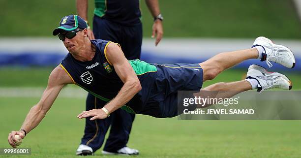 South African cricketer Mark Boucher dives to catch the ball during a practice at Sir Vivian Richards Stadium in St John's on May 18, 2010. South...