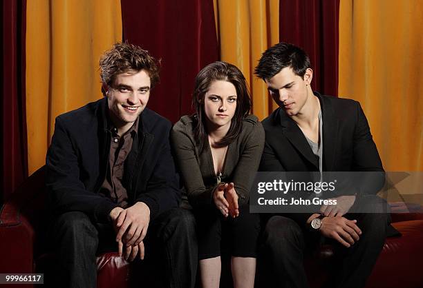 Actors Robert Pattinson, Kristen Stewart and Taylor Lautner pose for a private photo shoot at Marche on May 5, 2010 in Chicago, Illinois.