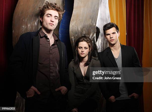 Actors Robert Pattinson, Kristen Stewart and Taylor Lautner pose for a private photo shoot at Marche on May 5, 2010 in Chicago, Illinois.