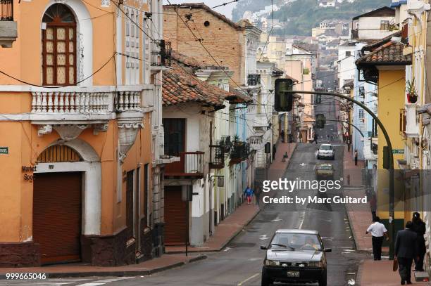 people walking on a steep street lined with colonial buildings in quito, ecuador - pichincha bildbanksfoton och bilder
