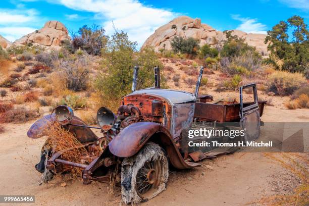 ca-joshua tree national park-abandoned vehicle - joshua tree ストックフォトと画像