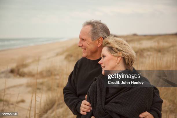 caucasian couple standing on beach - henley beach stock pictures, royalty-free photos & images