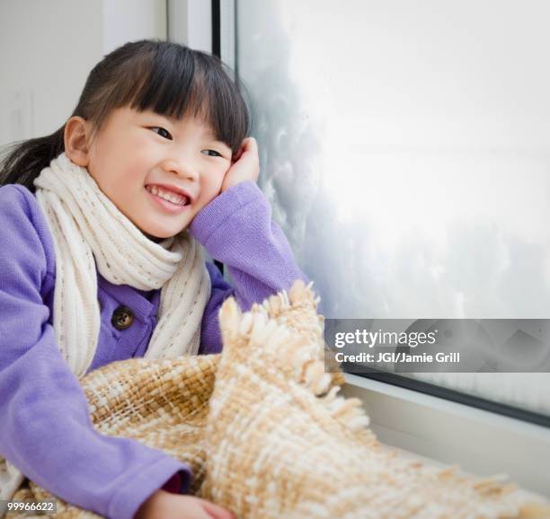 chinese girl with blanket looking out window - snow day stock pictures, royalty-free photos & images