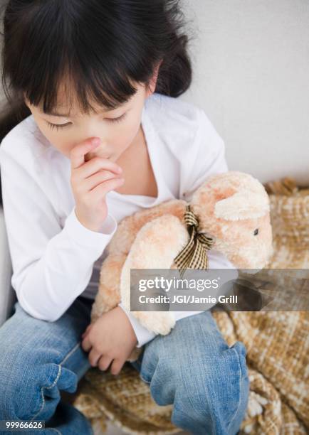 chinese girl sucking thumb and holding teddy bear - thumb sucking stock pictures, royalty-free photos & images