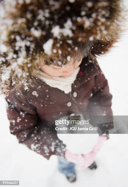 chinese girl holding snowball - jgi jamie grill stock pictures, royalty-free photos & images