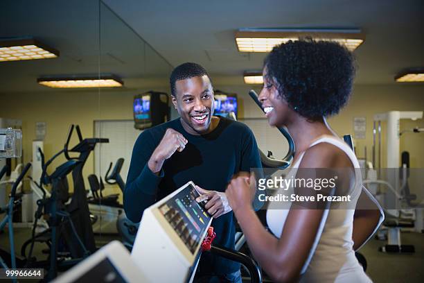 personal trainer motivating woman on treadmill - steve prezant stock pictures, royalty-free photos & images