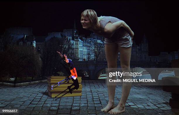 Dancer jumps in front of woman featured on a giant screen during a rehearsal of the Orphee opera, choregraphed by French Jose Montalvo and Dominique...