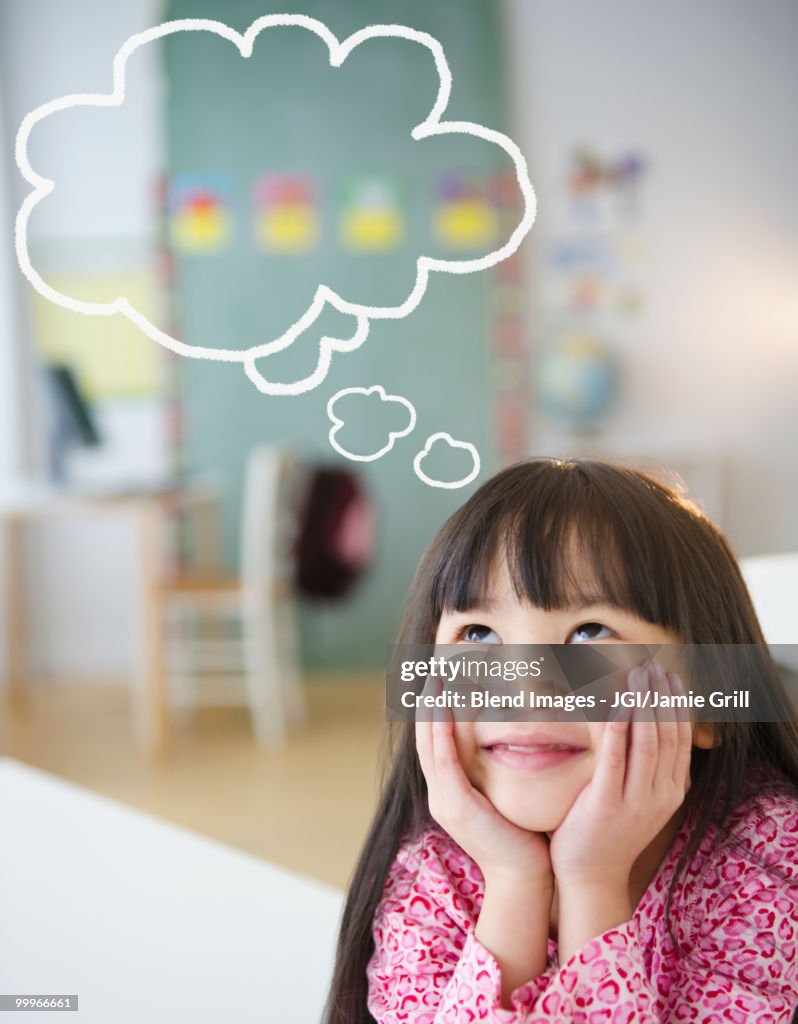 Chinese girl with thought bubble in classroom