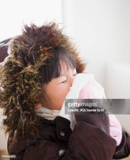 chinese girl in coat blowing nose - jgi jamie grill stock pictures, royalty-free photos & images