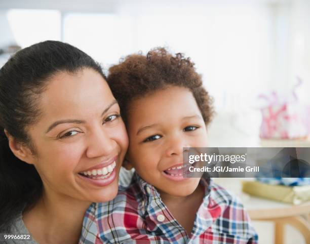 mixed race mother smiling with son - jgi jamie grill stock pictures, royalty-free photos & images