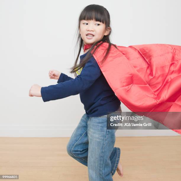 chinese girl superhero running with cape - jgi jamie grill stock pictures, royalty-free photos & images