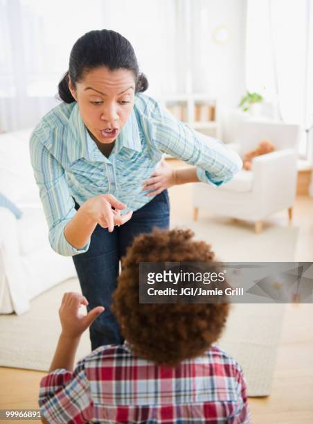 mixed race mother lecturing son - anschreien stock-fotos und bilder
