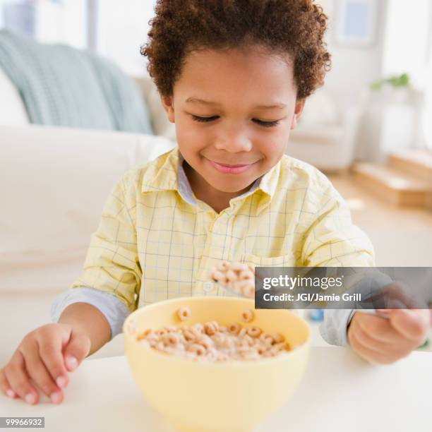 black boy eating bowl of cereal - jgi jamie grill stock pictures, royalty-free photos & images