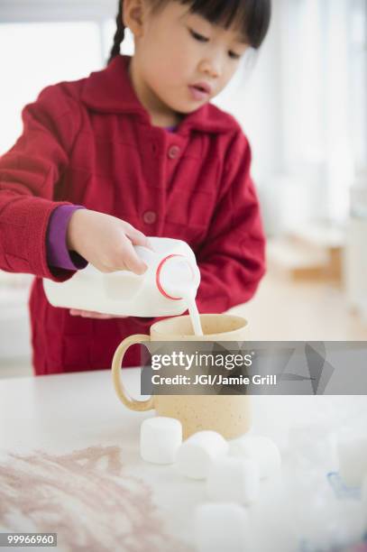 chinese girl making hot chocolate - jgi jamie grill stock pictures, royalty-free photos & images